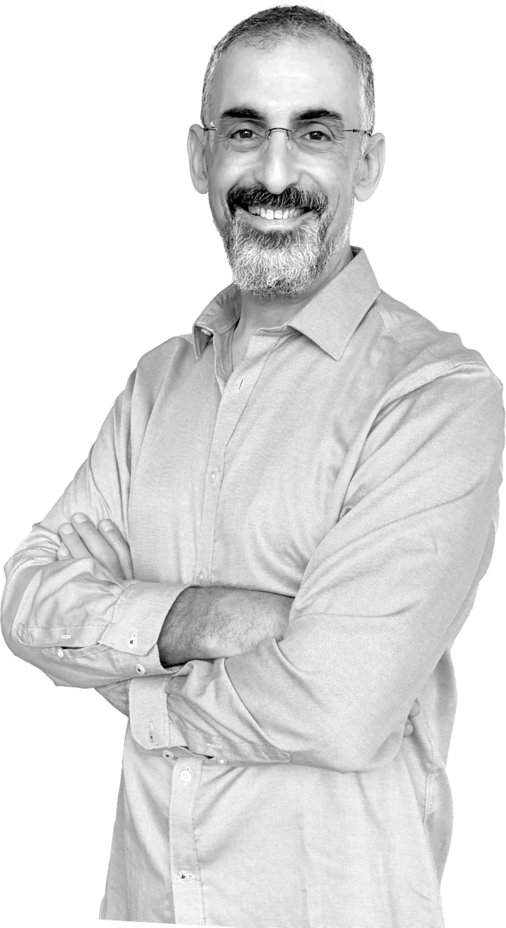 Gavrie Philipson, smiling, arms crossed, in a light shirt